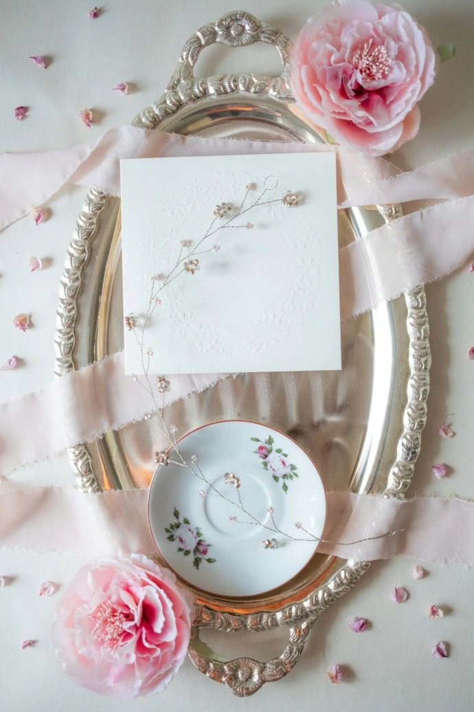 a plate with a card and some flowers on it